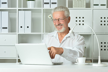 Image showing Mature businessman working with laptop