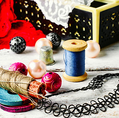 Image showing Jewelry and a sewing tool