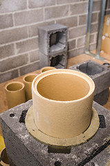 Image showing Construction of modular ceramic chimney in the house