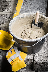 Image showing Tools for bricklayer bucket with a solution and a trowel, close-