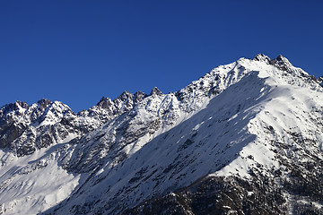 Image showing Snowy rocks and blue clear sky at nice sun day