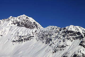 Image showing Snowy mountains and blue clear sky at cold sun day