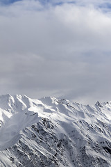 Image showing Sunlight snowy mountains and cloudy sky
