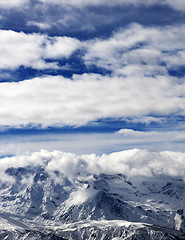 Image showing Sunlight snowy mountains in clouds