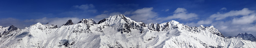 Image showing Large panoramic view on snowy mountains in sunny day