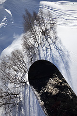 Image showing Snowboard over off-piste slope