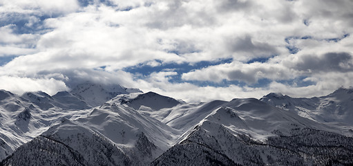 Image showing Panoramic view on snowy mountains and cloudy sky in evening