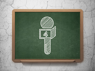 Image showing News concept: Microphone on chalkboard background