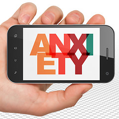 Image showing Medicine concept: Hand Holding Smartphone with Anxiety on  display