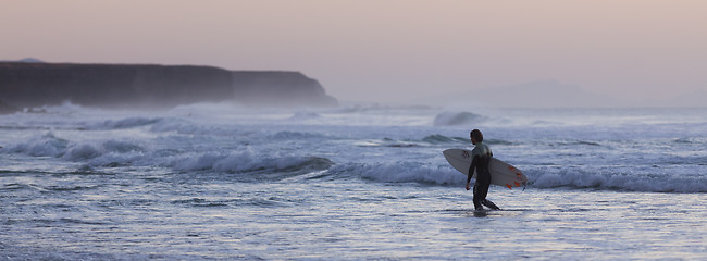 Image showing Surfers on beach with surfboard.