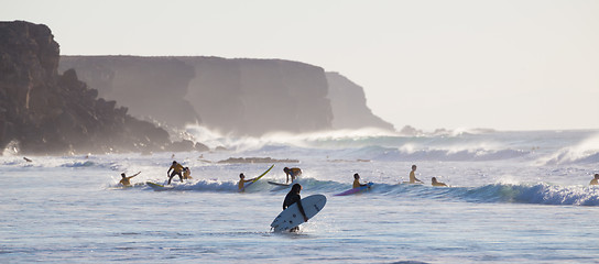 Image showing Surfers surfing on El Cotillo beach, Fuerteventura, Canary Islands, Spain.