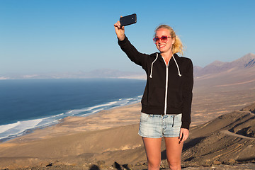 Image showing Woman snaping holiday selfie on El Cofete beach