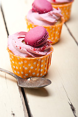 Image showing pink berry cream cupcake with macaroon on top