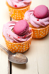 Image showing pink berry cream cupcake with macaroon on top