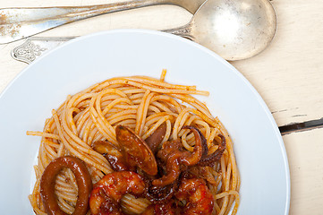 Image showing Italian seafood spaghetti pasta on red tomato sauce 