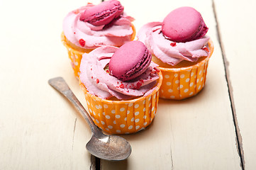 Image showing pink berry cream cupcake with macaroon on top