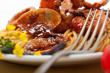 Image showing Italian seafood spaghetti pasta on red tomato sauce 