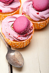 Image showing pink berry cream cupcake with macaroon on top