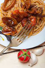 Image showing Italian seafood spaghetti pasta on red tomato sauce 