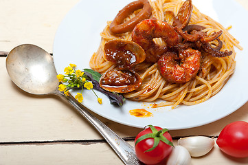 Image showing Italian seafood spaghetti pasta on red tomato sauce 