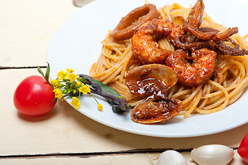 Image showing Italian seafood spaghetti pasta on red tomato sauce 