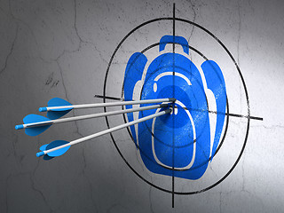 Image showing Tourism concept: arrows in Backpack target on wall background