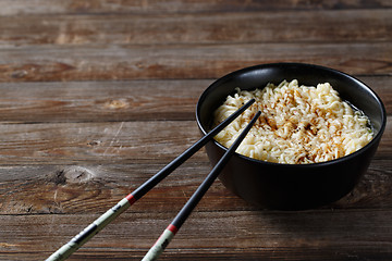 Image showing bowl of noodles with vegetables on wood table