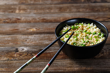 Image showing bowl of noodles with vegetables on wood table