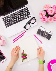 Image showing The female hands with a notebook