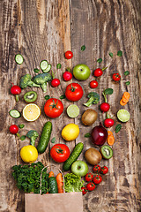 Image showing The vegetables from a paper bag on wooden table