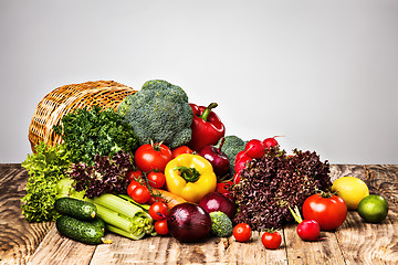 Image showing The vegetables from a  basket on wooden table