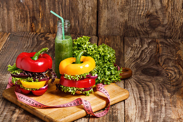 Image showing The bottles with fresh vegetable juices on wooden table