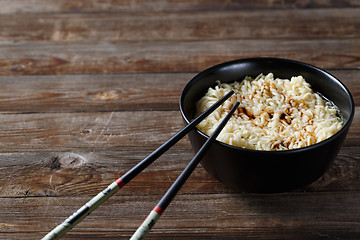 Image showing bowl of noodles with vegetables on wood table