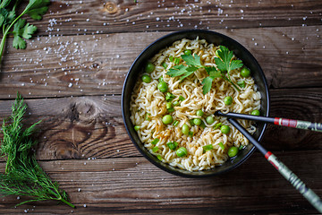 Image showing Chow Mein: fried noodles with chicken and vegetables close-up. horizontal view from above