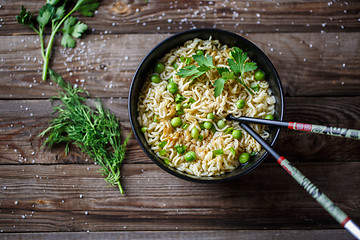 Image showing Chow Mein: fried noodles with chicken and vegetables close-up. horizontal view from above