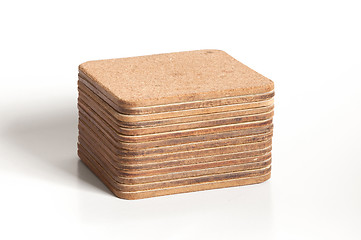 Image showing Pile of cork textured coasters isolated