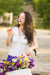 Image showing Happy girl with her bicycle