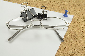 Image showing spectacles and bulldog clips on paper