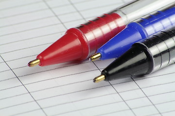 Image showing three pens on note paper