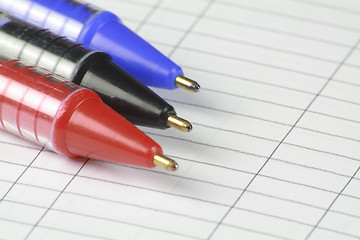 Image showing three pens on note paper