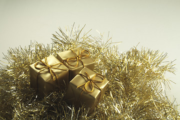 Image showing gold present box decorations with golden tinsel