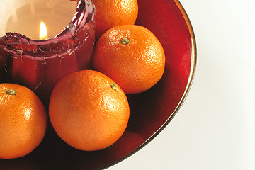 Image showing candle and fruit in a bowl