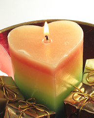 Image showing heart candle and presents in a red glass bowl