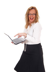 Image showing Business woman laughing at laptop.