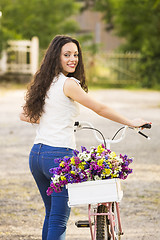 Image showing Happy girl with her bicycle