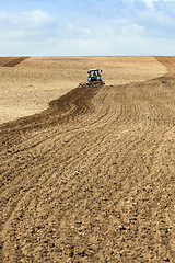 Image showing tractor plowing field 