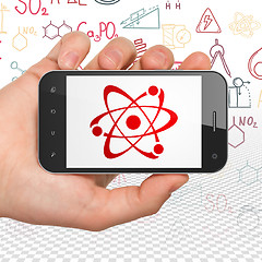 Image showing Science concept: Hand Holding Smartphone with Molecule on display