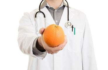 Image showing Nutritionist doctor, giving an orange, isolated