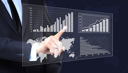 Image showing Businessman Touching a Graph Indicating Growth. business concept 