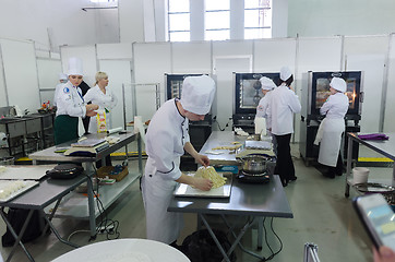 Image showing Young cooks prepare food in competition